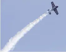  ?? CLIFFORD SKARSTEDT EXAMINER FILE PHOTO ?? Acrobatic performer Rick Volker spirals through the sky aboard his Sukhoi SU-26M aircraft during the Peterborou­gh Air Show.