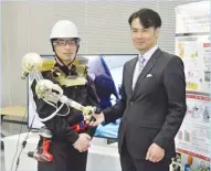  ??  ?? english.kyodonews.net A man wearing an arm-shaped robot poses with its developer, Waseda University professor, Hiroyasu Iwata, in Tokyo, Japan, on January 25, 2019.