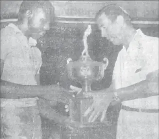  ?? ?? Mervyn Anthony receiving the Guyana national championsh­ip trophy