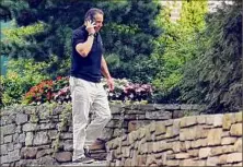  ?? Hans Pennink / Associated Press ?? Gov. Andrew M. Cuomo talks on the phone Aug. 7 outside the Executive Mansion in Albany.