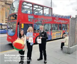  ??  ?? Welcome on board McGill’s staff are giving goodie bags to travellers