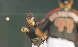  ?? RICK SCUTERI/THE ASSOCIATED PRESS ?? Diamondbac­ks second baseman Brandon Drury makes a throw against the Indians on Saturday in Phoenix. In the 11-2 win for the Diamondbac­ks, Drury scored a run and had three hits, raising his batting average to .526 (10 for 19) on the season.