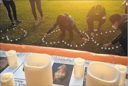  ?? JOHN GASTALDO PHOTOS ?? Supporters of San Diego’s Asian community display candles Saturday at a vigil for the women killed last week in Georgia.