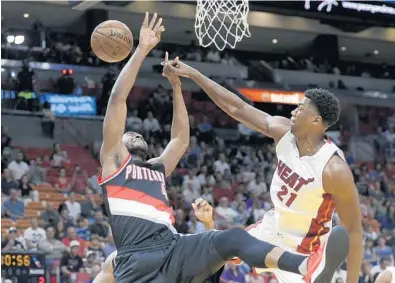  ?? LYNNE SLADKY/AP ?? Miami Heat’s Hassan Whiteside blocks a shot by Portland Trail Blazers’ Maurice Harkless in Sunday night’s victory by Portland, sending Miami from the seventh position to the ninth in the Eastern Conference.