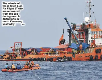  ?? AFP ?? The wheels of the ill-fated Lion Air Flight JT 610 are recovered from the sea during search operations in north Karawang yesterday.