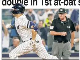  ??  ?? DOUBLE THE FUN: Giancarlo Stanton was all smiles (right) after hitting a double in his first at-bat in the second inning of the Yankees’ 3-2 loss.