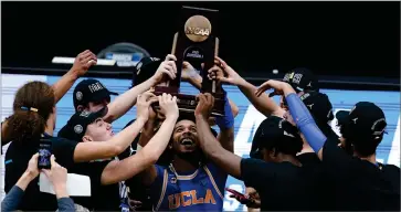  ?? AP PHOTOBY DARRON CUMMINGS ?? UCLA guard Tyger Campbell (10) celebrates with teammates after an Elite 8 game against Michigan in the NCAA men’s college basketball tournament at Lucas Oil Stadium, Wednesday, March 31, in Indianapol­is. UCLA won 51-49.