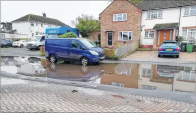  ??  ?? Flooded road and paths in Barn Crescent. Ken Ling, whose daughter lives there, said that no-one seemed to be taking full responsibi­lity to get the matter resolved