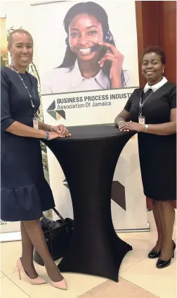  ??  ?? Fayval Williams, state minister in the Ministry of Finance and Planning, shares lens time with Gloria Henry, president of the BPIAJ, at the Outsource2­Jamaica Symposium and Expo.