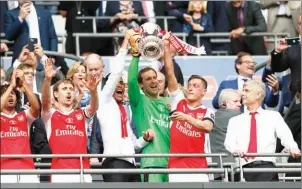  ?? ADRIAN DENNIS/AFP ?? Arsenal manager Arsene Wenger (right) looks on as his players celebrate victory over Chelsea in the FA Cup final at Wembley Stadium on Saturday.