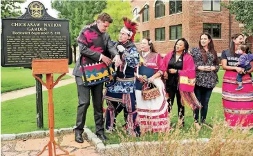  ?? [PHOTOS BY CHRIS LANDSBERGE­R, THE OKLAHOMAN] ?? Mayor David Holt, left, is honored with a Native American blanket on Monday by Russ Tall Chief during Oklahoma City’s first recognitio­n of Indigenous Peoples Day at the Chickasaw Sculpture Garden on the campus of Oklahoma City University. Oklahoma City mayor David Holt read a proclamati­on to mark the day as Indigenous Peoples Day.