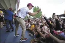  ?? AP photo ?? Josh Harris, the leader of a group buying the Washington Commanders, high-fives fans during a pep rally at FedEx Field on Friday.