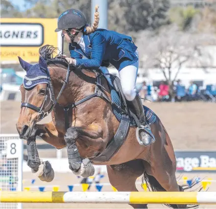  ?? Picture: Nev Madsen ?? IN FLIGHT: Katie Bunker of Fairholme College at the Interschoo­ls Equestrian Queensland State Championsh­ips.