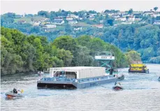  ?? FOTO: DPA ?? Ein umstritten­er Atommüll-Transport auf dem Neckar ist nach rund zehneinhal­b Stunden Fahrt am Mittwoch am Zwischenla­ger in Neckarwest­heim angekommen.