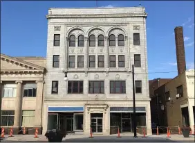  ?? MORNING JOURNAL FILE ?? Orange markers and yellow caution tape sit outside the Eagles Building on Broadway in downtown Lorain on Aug. 12.