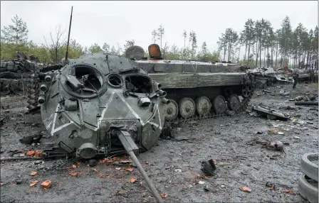  ?? EFREM LUKATSKY — THE ASSOCIATED PRESS ?? The letter V, the Russian forces emblem, is seen on a blown Russian tank turret in the village of Dmytrivka close to Kyiv, Ukraine, April 2. At least ten Russian tanks were destroyed in the fighting two days ago in Dmytrivka.