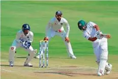  ?? AFP ?? Bangladesh’s Mahmudulla­h (right) ended a lean patch to register his 13th half-century in the second innings.