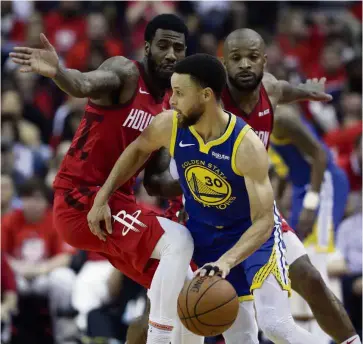  ?? — AP ?? On fire: Golden State Warriors guard Stephen Curry dribbles past Houston Rockets guard Iman Shumpert (left) and forward PJ Tucker during the NBA second-round playoff series in Houston on Friday.