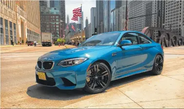  ?? (Robert Duffer/Chicago Tribune/TNS ?? The 2016 BMW M2 in Long Beach Blue Metallic coat, north of the Franklin Street Bridge in Chicago, on May 31, 2016. A joy to drive, everything about it feels right.