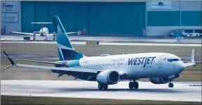  ??  ?? A WestJet Airlines Boeing 737 Max aircraft arrives at Vancouver Internatio­nal Airport on Thursday. The flight from Calgary is the first commercial Boeing 737 Max flight in Canada since the aircraft was grounded worldwide in 2019.