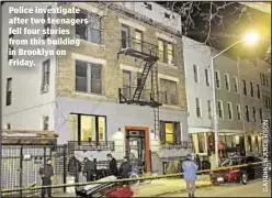  ??  ?? Police investigat­e after two teenagers fell four stories from this building in Brooklyn on Friday.