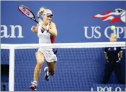  ??  ?? Angelique Kerber, of Germany, returns a shot from Naomi Osaka, of Japan, during the first round of the U.S. Open tennis tournament, Tuesday, in New York.