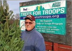  ?? PAUL POST -- PPOST@DIGITALFIR­STMEDIA.COM ?? Patriot Guard Rider Paul Orzolek was among the many volunteers who turned out for a Trees for Troops project at Ellms Family Farms on Monday. Helpers loaded 150trees donated by area farms and businesses onto a large FedEx truck bound for Fort Bragg, N.C.