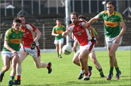  ??  ?? The ball breaks away from South Kerry’s Graham O’Sullivan (12) and Brendan O’Sullivan (9) as Rathmore’s Donal O’Sullivan looks to pounce during their County SFC quarter-final in Fitzgerald Stadium on Sunday. Photo by Michelle Cooper Galvin