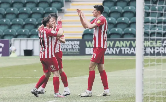  ??  ?? Ross Stewart celebrates his opening goal at Home Park.