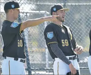  ??  ?? Pitchers Jameson Taillon, left, and Joe Musgrove talk at the first fullsquad workout Monday at Pirate City in Bradenton, Fla.