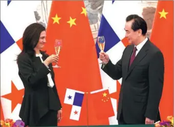  ?? FENG YONGBIN / CHINA DAILY ?? Foreign Minister Wang Yi and Panamanian Vice-President and Foreign Minister Isabel de Saint Malo toast the signing of a joint communique on establishi­ng diplomatic relations on Tuesday in Beijing.