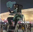  ?? — AP ?? Chanting away: a street marshal at work prior to the match between brazil and Serbia at the Lusail Stadium on thursday.