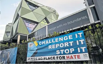  ?? ?? Centre of the storm: An anti-racism banner hangs on the railings outside Headingley, which has been stripped of its Test status