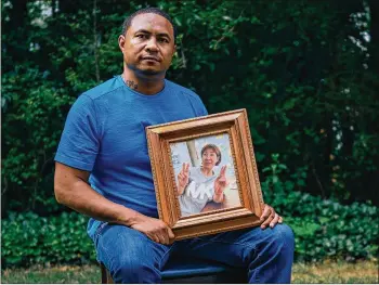  ?? MELISSA ALEXANDER FOR THE WASHINGTON POST ?? LEFT: Robert Peterson sits for a portrait outside of the home of his late mother, Yong Ae Yue, in Norcross. Yue was shot and killed in an Atlanta-area spa earlier this year. MELISSA ALEXANDER FOR THE WASHINGTON POST TOP RIGHT: Elliott Peterson, older son of Yong Ae Yu, holds a small urn containing ashes of her late mother at his mother’s home. HYOSUB SHIN / HYOSUB.SHIN@AJC.COM BOTTOM RIGHT: Family albums of photos of Yong Ae Yue are displayed inside her home.