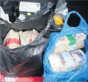  ??  ?? WADS: HMRC officers found cash in Singh’s car boot, glovebox and in bags at his home