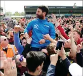  ??  ?? VICTORY PARADE: Manager Danny Cowley is hoisted onto the shoulders of jubilant fans