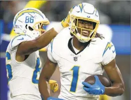  ?? Kyusung Gong Associated Press ?? CHARGERS wide receiver Quentin Johnston (1) smiles after scoring a touchdown during the first half of the team’s win over the Rams on Saturday.
