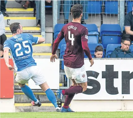  ??  ?? Above: Chris Kane watches his shot beat Hearts keeper Viktor Noring for Saints’ winner; below: Danny Swanson is congratula­ted by Joe Shaughness­y as his career as a St Johnstone player comes to an end to a standing ovation from the home fans; right:...