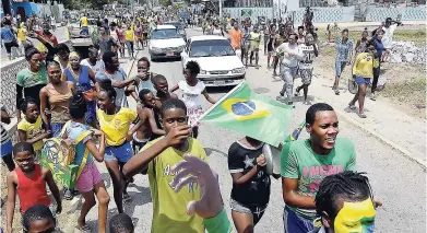  ??  ?? Brazil supporters celebrate the win through the communitie­s of Trench Town and Arnett Gardens after the match between Brazil and Mexico yesterday.