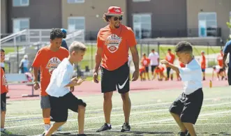  ?? Joe Amon, The Denver Post ?? Broncos running back Phillip Lindsay oversees participan­ts in his football camp Monday at the Evie Garrett Dennis Campus. “I was in their shoes,” Lindsay said.