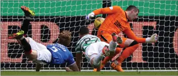  ??  ?? Mohamed Elyounouss­i dives to put Celtic ahead