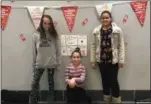  ?? SUBMITTED PHOTO ?? Pictured with their finished hallway Red Ribbon display are Abigail Replogle, Amberly Bravo and Kayla Fowler.