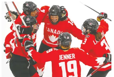  ?? DARREN MAKOWICHUK ?? Canada celebrates Jamie Lee Rattray's goal against USA goalie Nicole Hensley during the women's world championsh­ip gold-medal game in Calgary on Tuesday.