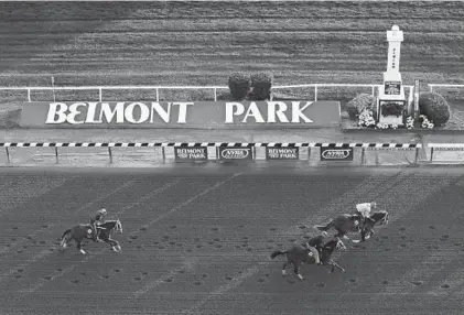  ?? AL BELLO/GETTY ?? Exercise riders give horses a workout in preparatio­n for the Belmont Stakes, which has its 151st running Saturday in Elmont, N.Y.