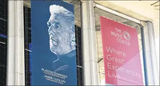  ?? Frederic J. Brown / AFP/Getty Images ?? A banner showing Placido Domingo, the Los Angeles Opera’s general director, hangs from the Dorothy Chandler Pavilion, home to the opera, on Tuesday. The Los Angeles Opera said Tuesday it would probe sexual harassment allegation­s made by several women against Domingo.
