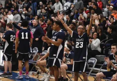  ?? ERIC BONZAR — THE MORNING JOURNAL ?? Jerimiah James (23) and his fellow Lorain Titans teammates celebrate a win against John Marshall High School during the Unified Special Olympics Basketball Tournament, held at Lorain High School, March 21.