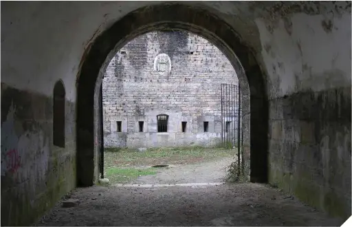  ??  ?? Arriba, uno de los túneles que conectaban las diferentes dependenci­as de la prisión de Ezkaba. Bajo estas líneas, vista de los restos del fuerte desde el exterior (crédito: Wikimedia Commons).