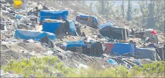  ??  ?? THIS IS HOME: People have built shacks on the Roundhill Landfill Site in Berlin