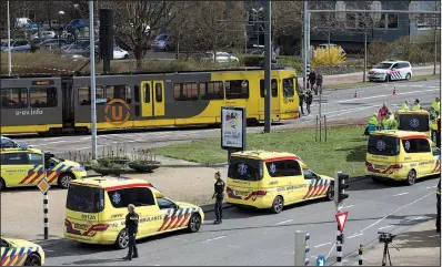  ?? AP/PETER DEJONG ?? Ambulances are parked Monday next to a tram after a shooting in Utrecht, Netherland­s, in which at least three people were killed.