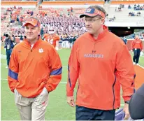  ?? Mark Crammer/ The Independen­t-Mail via AP ?? ■ In this Sept. 17, 2011, photo, then-offensive coordinato­rs Chad Morris, left, of Clemson, and Gus Malzahn, right, of Auburn, walk together on the field at Memorial Stadium before a game in Clemson, S.C. Morris is now the head coach at Arkansas. Malzahn is the head coach at Auburn. The two chat each week — except when they play each other.